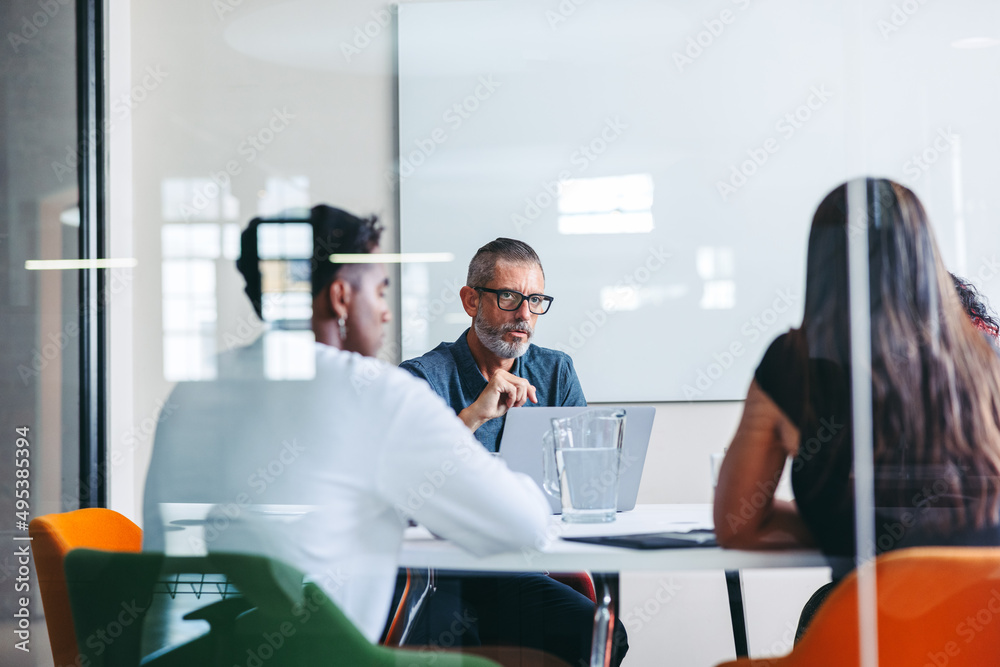 Group of businesspeople having a discussion in a meeting room - obrazy, fototapety, plakaty 