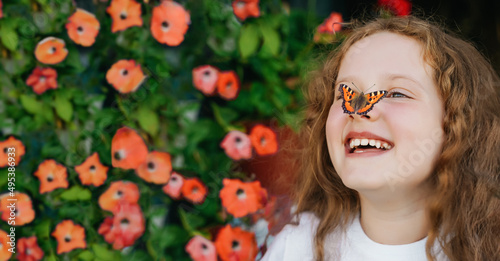 Canvas Print Laughing girl with a butterfly on his nose.