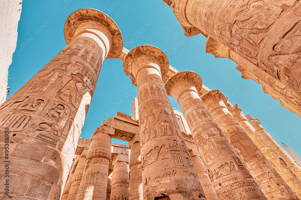 Hypostyle Hall with huge columns in Karnak temple in the famous city of Luxor. Travel attractions and heritage in Egypt