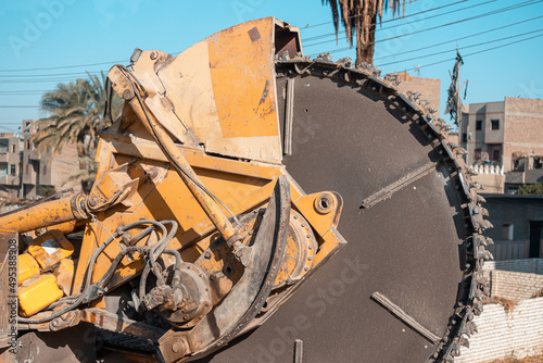 Fotografie Heavy machine drum cutter and a trencher for cable laying and construction work