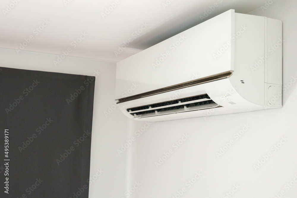 Air conditioner on white wall room interior background Air conditioner on white wall room interior background