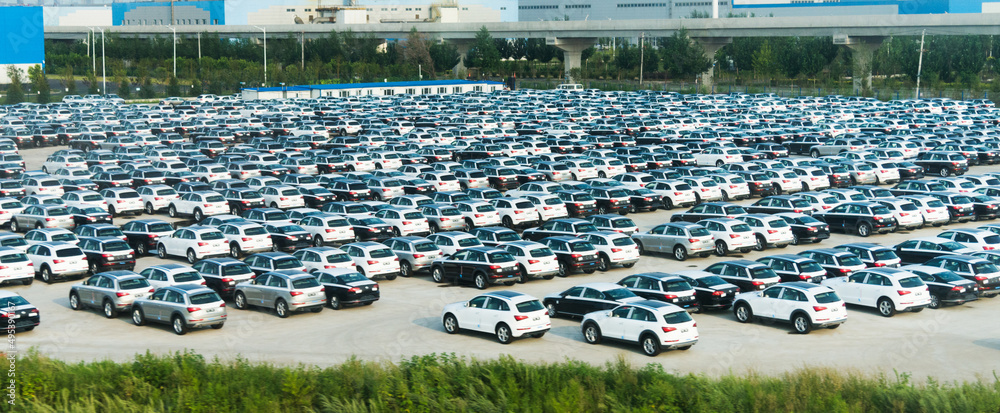 New cars parked at distribution center, automobile factory