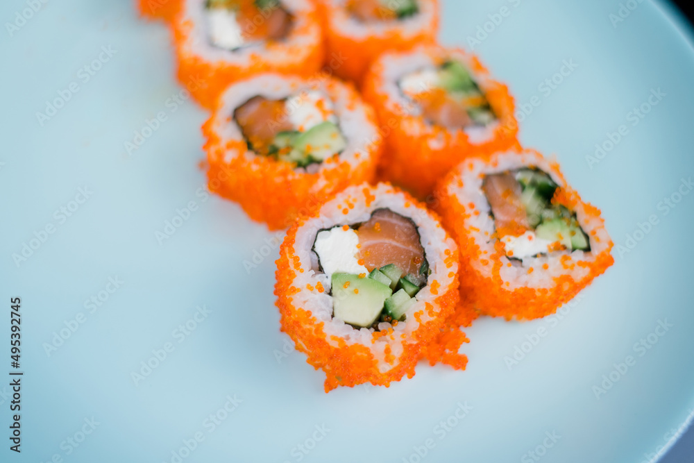 a roll with salmon and rice with tobiko caviar a roll with salmon and rice with tobiko caviar