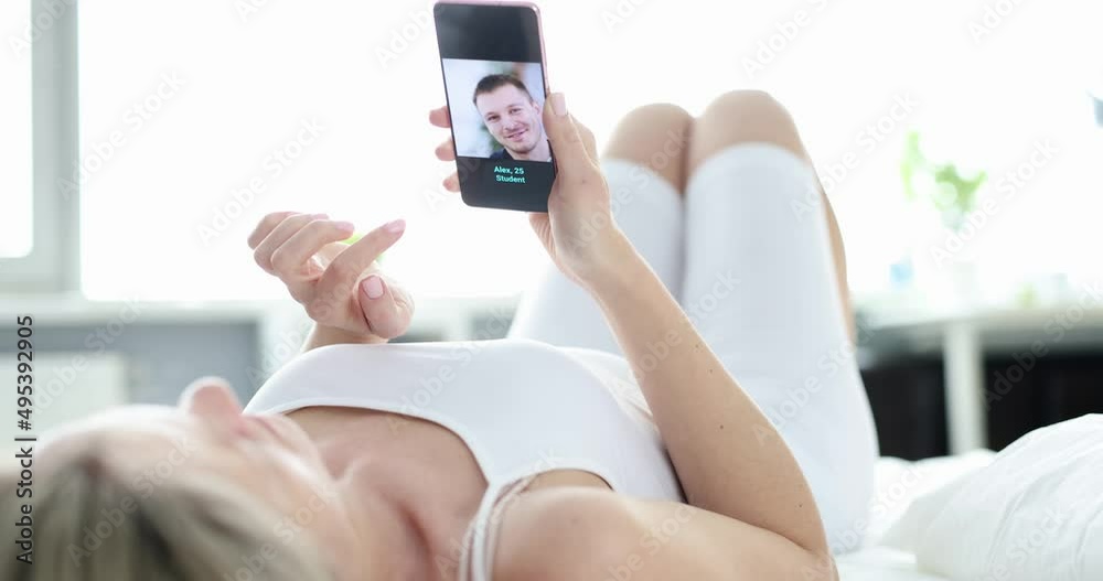 Young woman chooses man on dating site