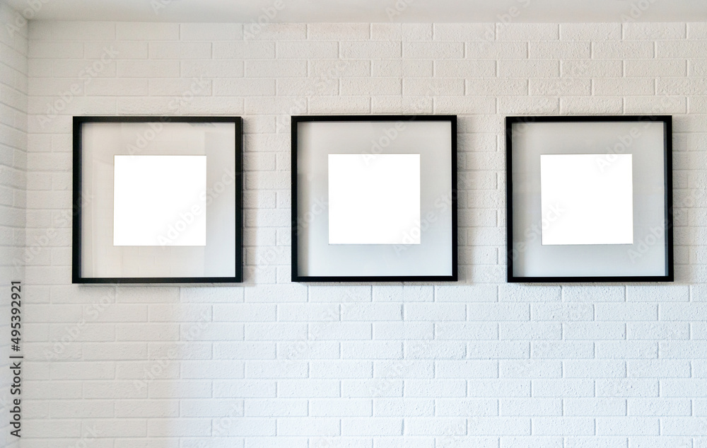 Group of wooden picture frames on white brick wall Group of wooden picture frames on white brick wall