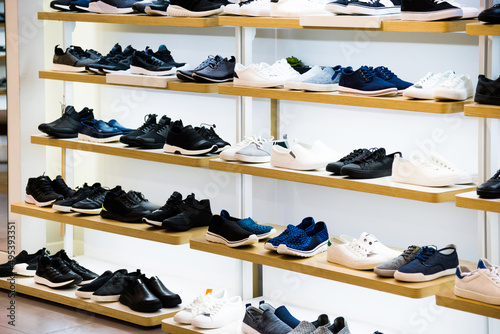 Male shoes on wooden shelf in the store