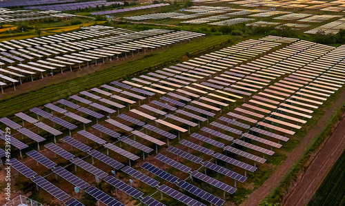 Aerial shot of sunrise sunlight shining on solar photovoltaic panels