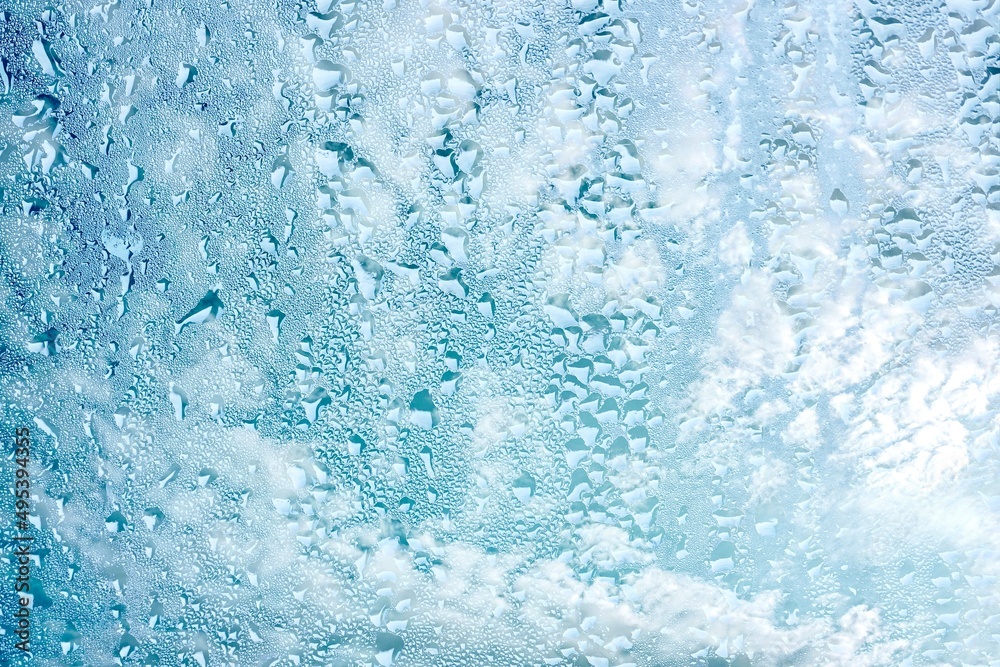 raindrops on the window and blue sky background