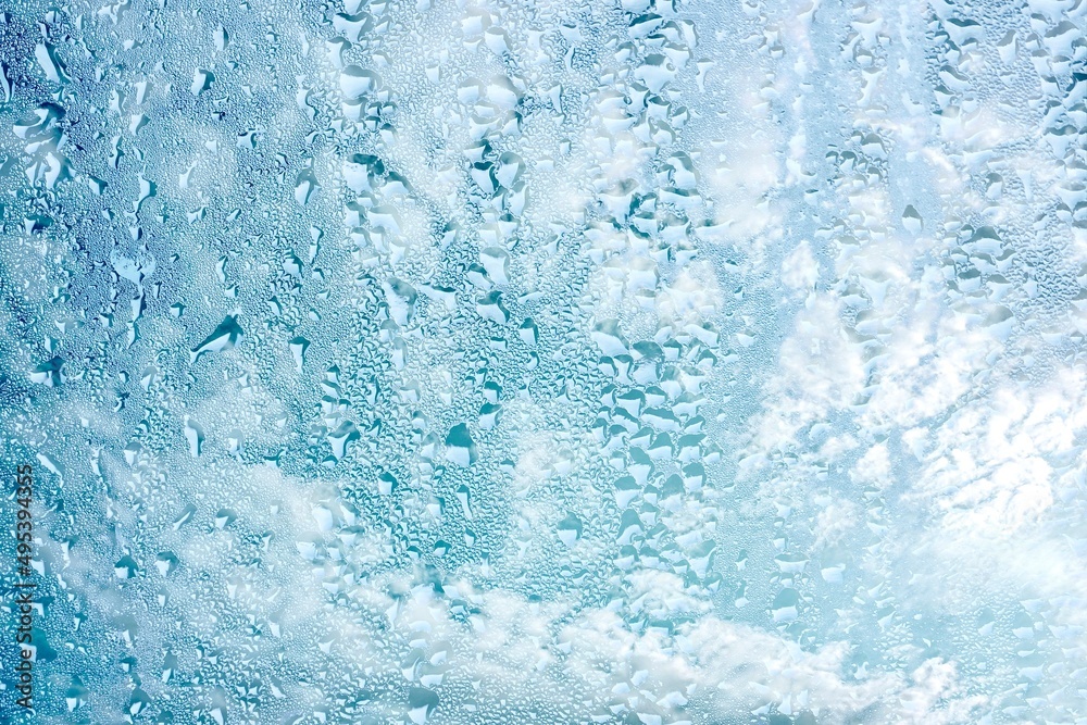raindrops on the window and blue sky background raindrops on the window and blue sky background