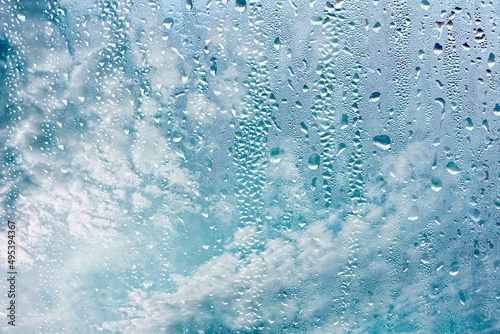 raindrops on the window and blue sky background