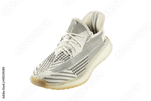 Gray rag sneaker isolated on white background. Cheap sports shoes.