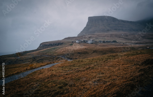 View of the Gasadalur on Vagar island. A small village situated on the slope of a hill. Gasadalur  Faroe Islands. November 2021  dramatic landscape