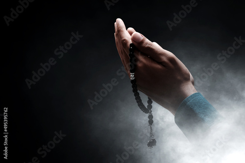 Muslim man praying with rosary beads photo