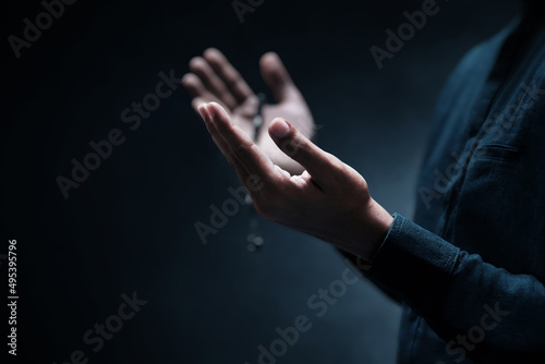 Muslim man praying on dark background