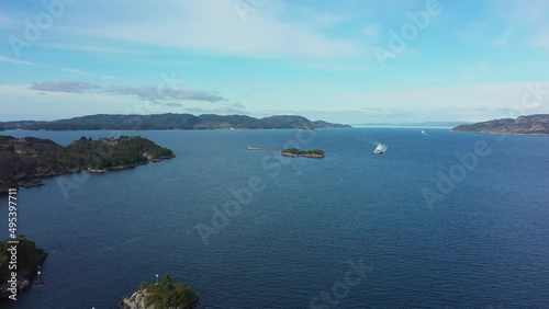 Torghatten ferry Flatoy is approaching Sandvikvaag with Bjornafjorden sea in background - Static aerial overview Norway photo