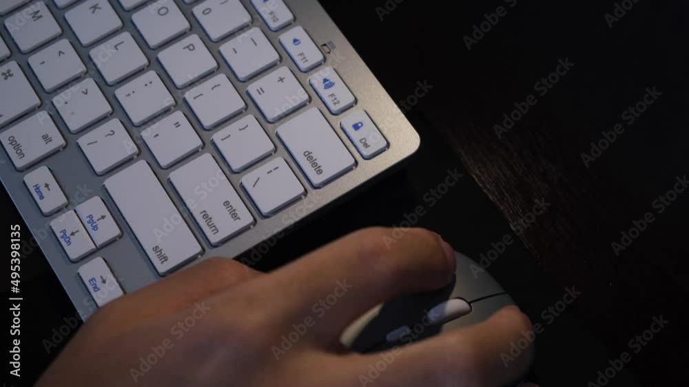 Hand Working On Desk With Wireless Computer Mouse And Keyboard. overhead Hand Working On Desk With Wireless Computer Mouse And Keyboard. overhead