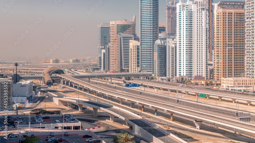 Obraz premium Dubai Marina skyscrapers and Sheikh Zayed road with metro railway aerial timelapse, United Arab Emirates