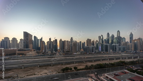Dubai marina tallest block of skyscrapers day to night timelapse.
