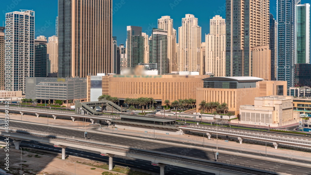 Dubai marina skyscrapers around shopping mall aerial all day timelapse from above.