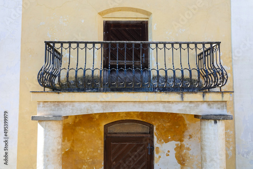 Beautiful spacious balcony with a decorative railing above the entrance of an old building of Lowit's mill in Prague near Palmovka, Czech Republic. High quality photo
