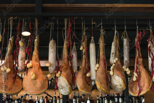 Dry and salty jamon legs hanging on a bar counter