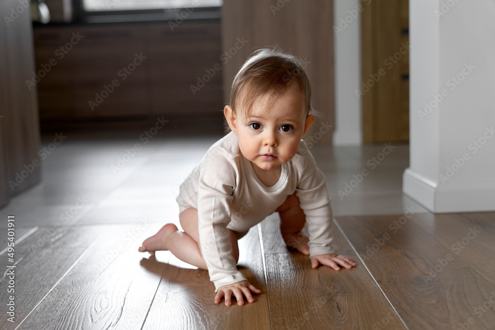 First steps of little girl at home interior First steps of little girl at home interior