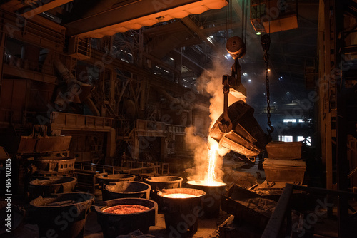 Tank pours liquid metal in the molds at the steel mill. Interior of a steel mill.