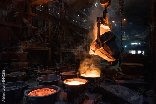 Tank pours liquid metal in the molds at the steel mill. Interior of a steel mill.