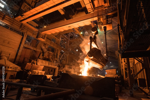 Tank pours liquid metal in the molds at the steel mill. Interior of a steel mill.