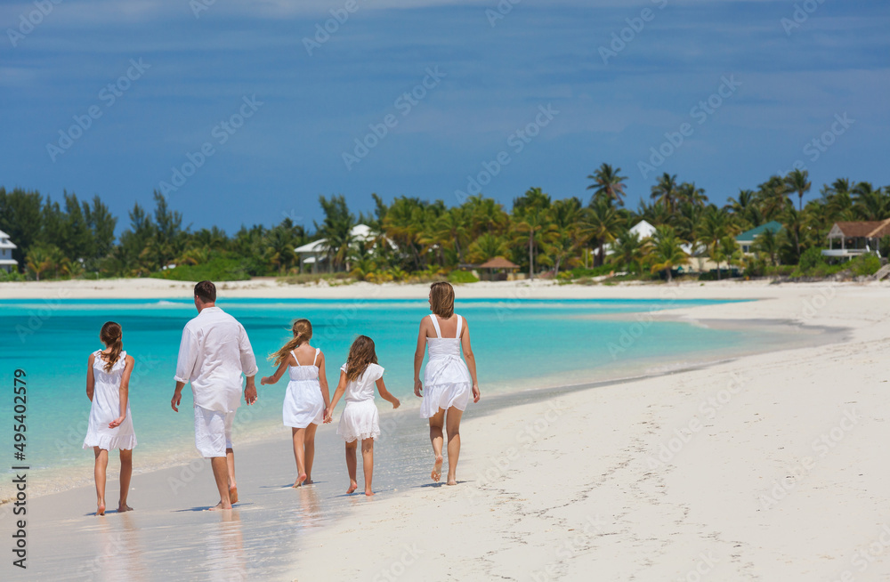 Caucasian parents and daughters on island beach vacation