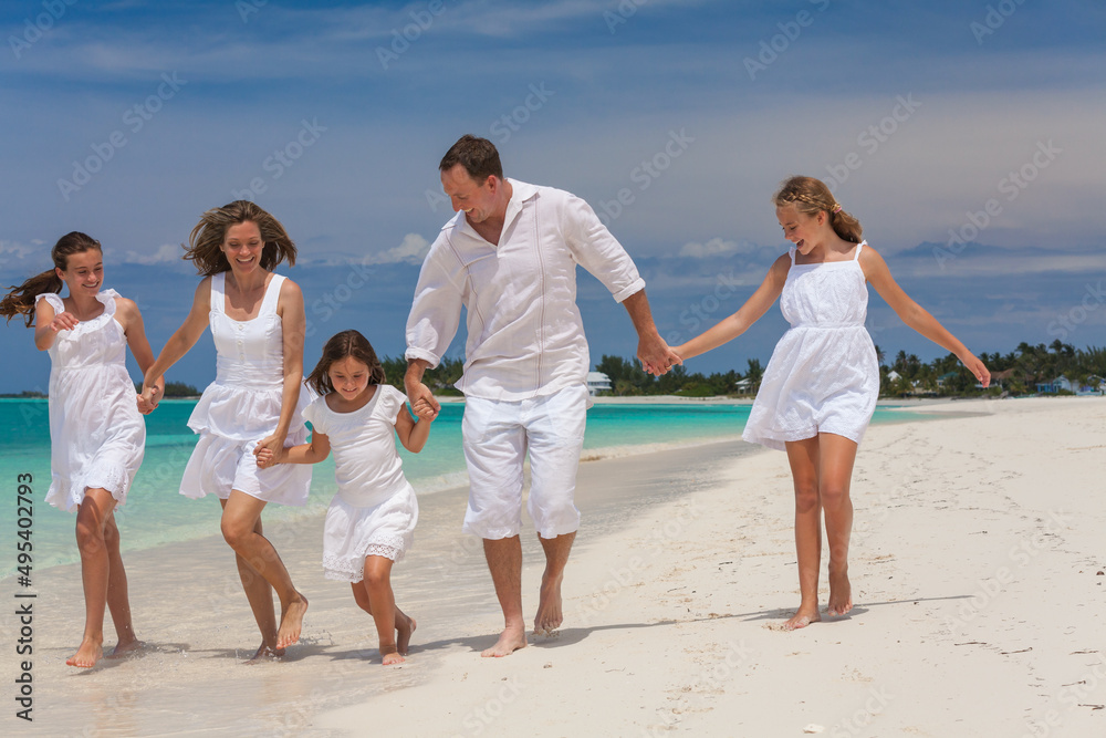 Caucasian parents and daughters on island beach vacation