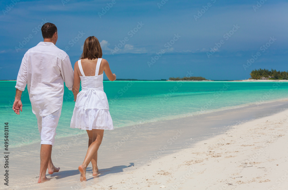 Barefoot Caucasian couple carefree on a tropical resort Barefoot Caucasian couple carefree on a tropical resort