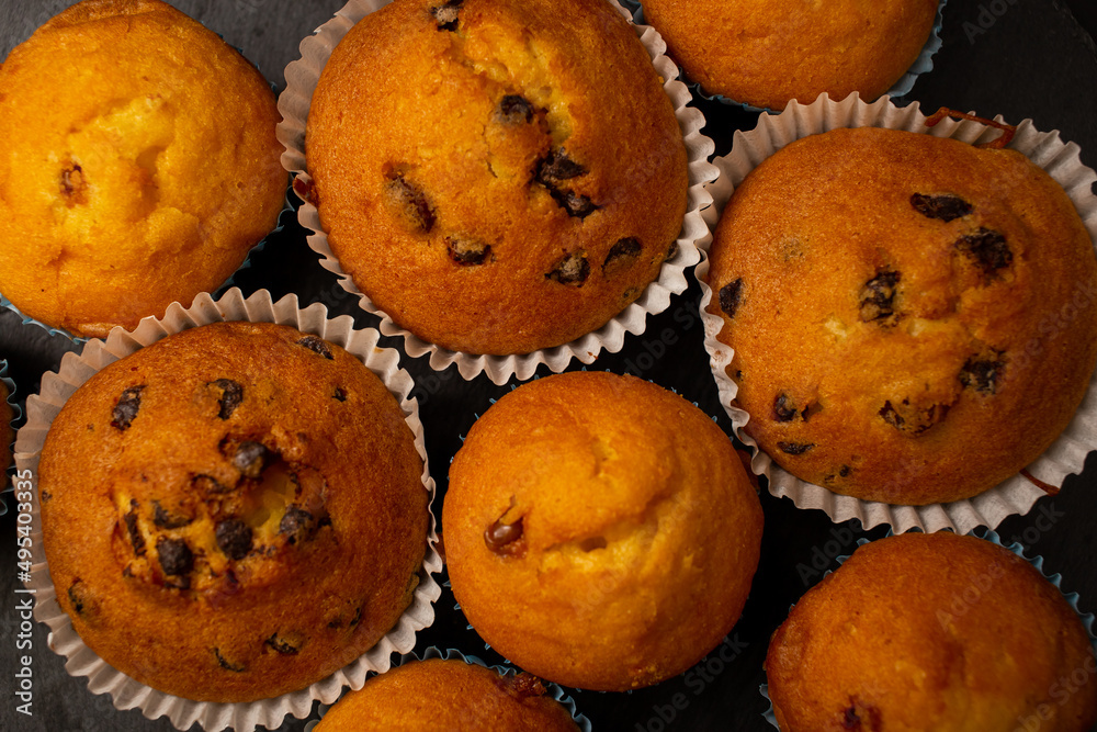 Juicy cupcakes on a black background, confectionery, bakery Juicy cupcakes on a black background, confectionery, bakery