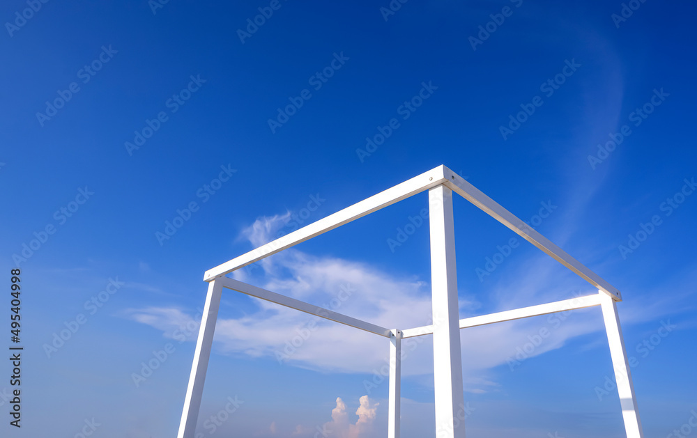 Simplicity summer background of white transparent cubic stand structure for travel photography against blue sky background Simplicity summer background of white transparent cubic stand structure for travel photography against blue sky background