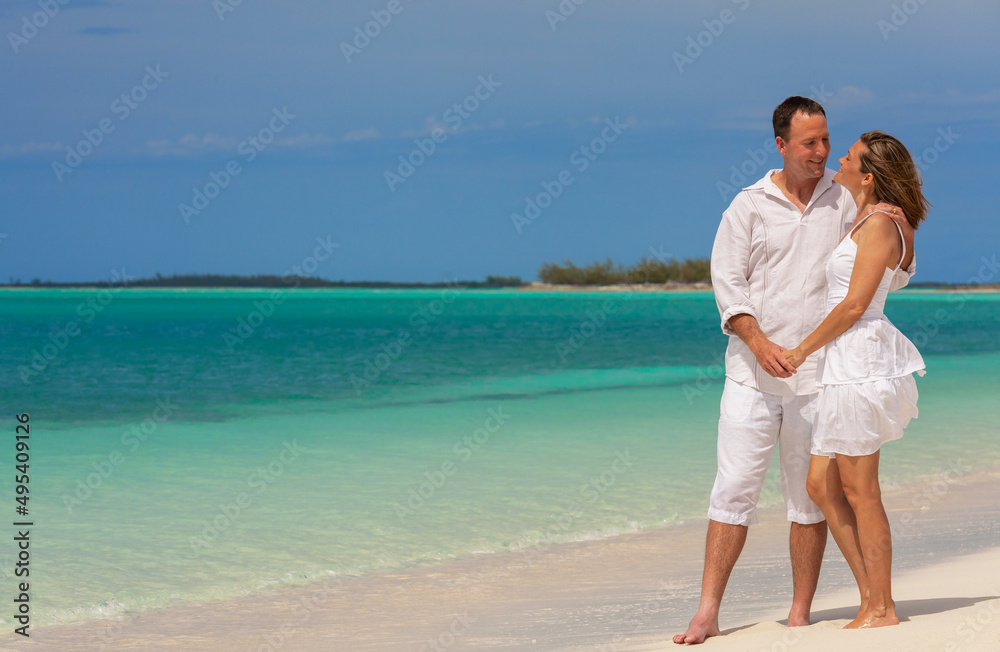 Healthy loving Caucasian couple on beach holiday Caribbean