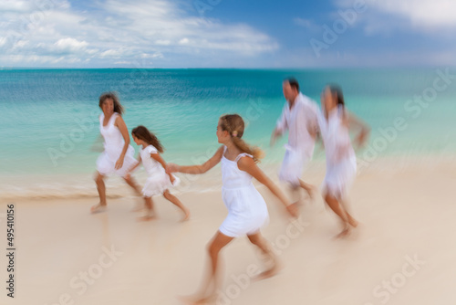Young Caucasian family having fun by tropical ocean