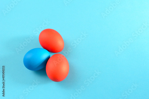 painted in red and blue easter eggs on sky blue background, close-up