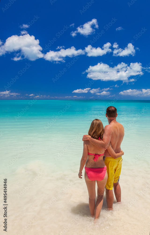 Happy Caucasian male and female on luxury beach