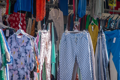 23 March 2022, Leiden, Netherlands, Women fashion, colorful clothes hanging on outdoor street market in the sunny day