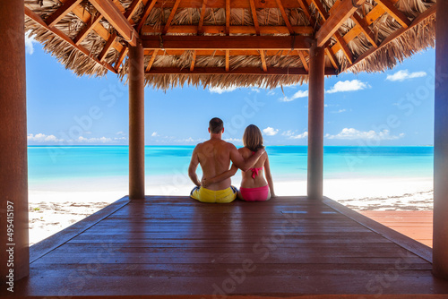 Obraz na plátne Male and female in tropical hut on beach