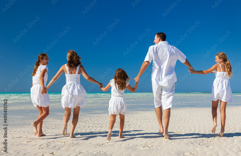 Caucasian family enjoying leisure walking on tropical beach