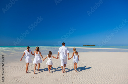 Caucasian family enjoying leisure walking on tropical beach