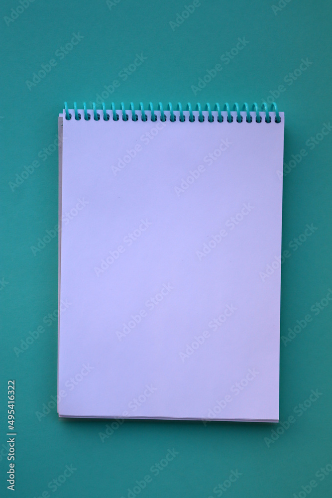 Planner layout, open blank spiral notebook for design, lettering, text, template. Blue background, pen. Planner layout, open blank spiral notebook for design, lettering, text, template. Blue background, pen.