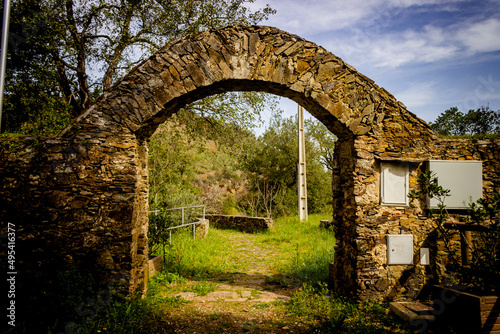 Fototapeta Naklejka Na Ścianę i Meble -  Ancient and beautiful stone entrance to a natural park in Algarve hills - Portugal