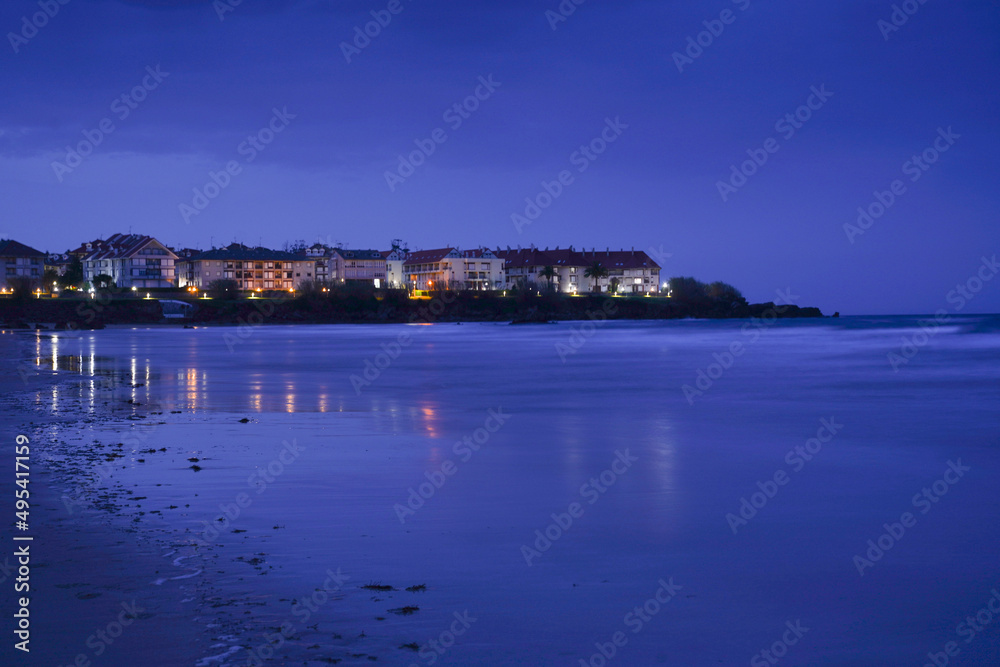 coastal town next to the beach at night