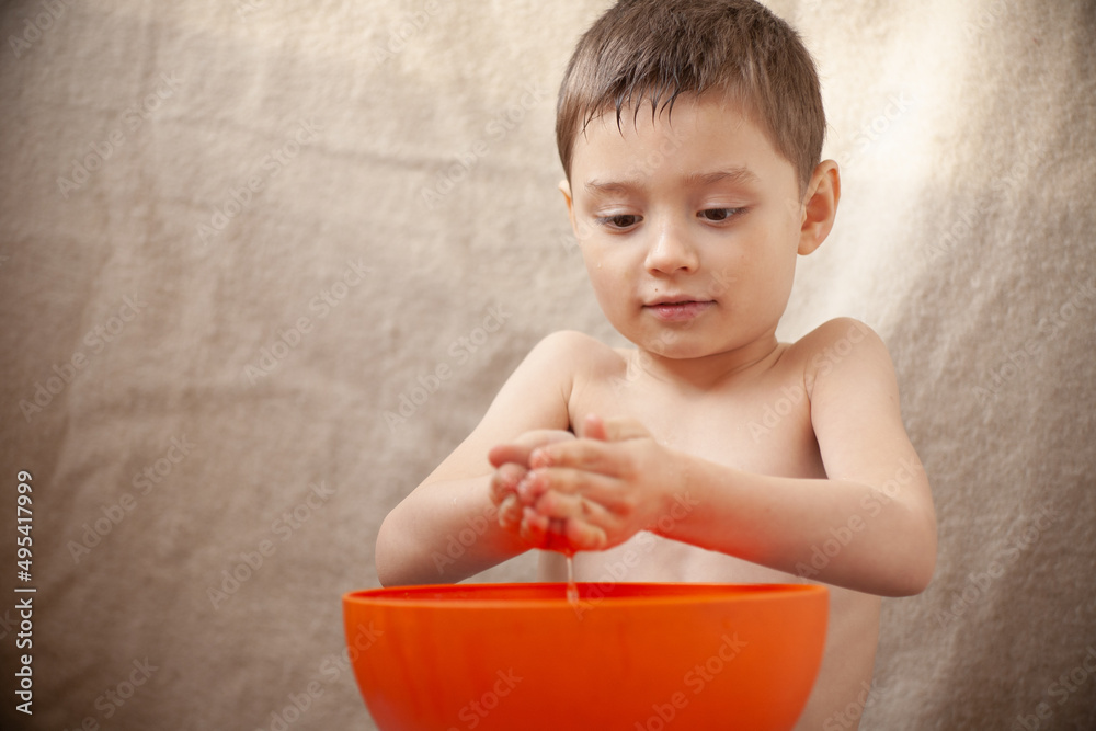 The child is washed with water The child is washed with water