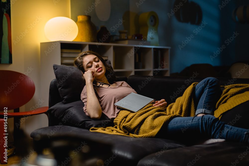 Fototapeta premium woman napping at home. she fell asleep while reading book