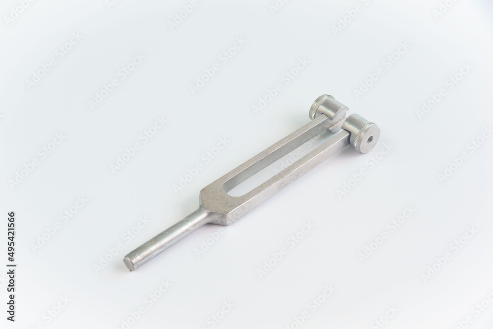 A tuning fork for neurological examination on white background. A tuning fork for neurological examination on white background.
