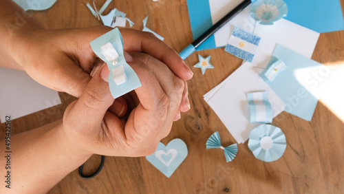 Hands holding Argentine cockade, argentina flag, in the background materials to do it