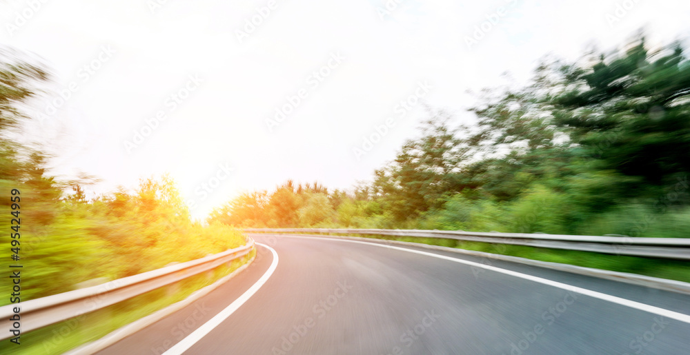 Empty curved road in motion blur